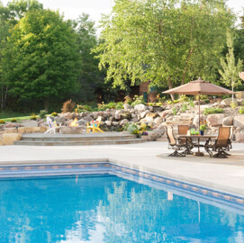 Backyard pool next to an outdoor fire pit and patio